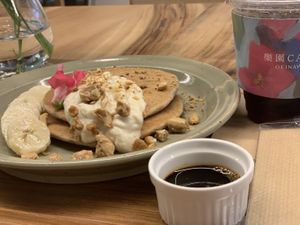 Pancakes with brown sugar syrup and nuts. You can order without whipped cream. I’m not sure what is the whipped cream made from. It was my non vegan friend order.  at Rakuen Cafe in Naha
