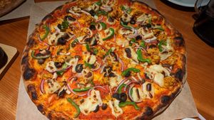 Pizza with vegan cheese and sausage as option. Not on menu but owner offered on request. at Kokopelli Pizza in Yomitan