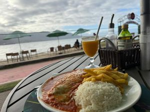 Zucchini cover with cheese and tomato sauce with potato chips, rice and beans. Lots of food! at Pimenta de Cheiro in Sao Paulo