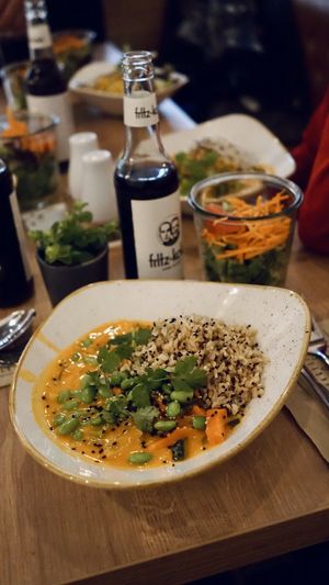 Vegan red thai curry with a side salad at Dean & David in Erfurt