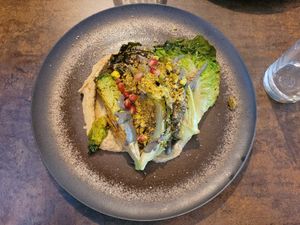 Starter: Hummus, roasted sucrine lettuce, black sesame cream, white pepper, pomegranate seeds and roasted pistachio. at Le Potager de Charlotte - Rennequin in Paris