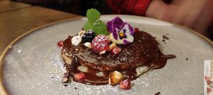 Chocolate mousse, rasperries, caramelised pecans and chocolate flakes. at Le Potager de Charlotte - Rennequin in Paris