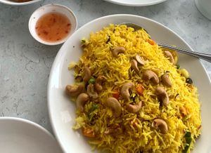 Cashew yellow rice with carrots and peas 🫛  at Zen Garden in Great Neck