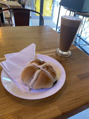 Hot cross bun and latte to sit in  at Dough Artisan Bakehouse in South East London