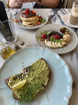 Avocado toast, banana bread donut, classic pancakes with Nutella, macchiato   at Manjerica in Lisbon