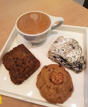 Yum yum mocha (oat milk), bonus coffee, blueberry scone, macadamia chocolate banana bread. at Bonus Bakery in Vancouver