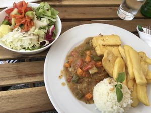 part of the 3-course vegan lunch: salad with pumpkin seed oil + main dish: potatoes, seitan steak, vegetable sauce, rice and fried tofu at Gostilna Pri Pošti in Ptuj
