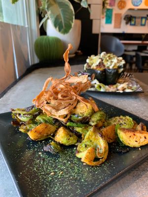 Brussels sprouts marinated in matcha salsa topped with fried parsnip chips and furikake seasoning. at Tender Loving Coffee in Chico