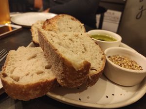 Bread with olive oil and seeds at Nola Kitchen in Porto