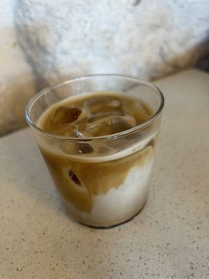 Ice coffee latte with oat milk and cardamom  at Nola Kitchen in Porto