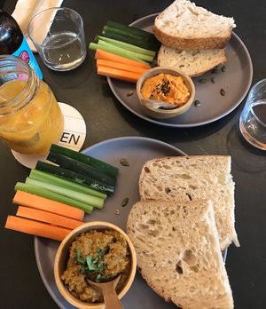 Roasted red pepper hummus and sundried tomato pesto with sourdough and veggie sticks  at Nola Kitchen in Porto