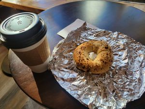 Vanilla latte with a cream cheese bagel at Familiars in Brooklyn