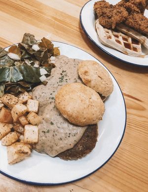 potatoes, biscuits, sosage Pattie, greens & gravy  at Dirty Kitch in Coventry