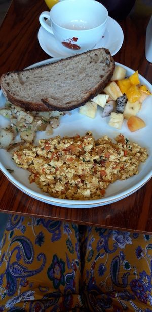 Scrambled tofu with potatoes and toast served with fruit at Pumpkin Tales in Chennai