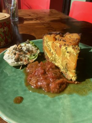 Butternut tofu quiche with chutney and Caesar salad ball  at Vegabond - West in Amsterdam