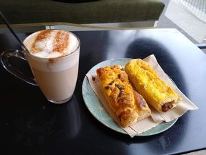 chai latte and spinach and sausage rolls at Vegabond - West in Amsterdam