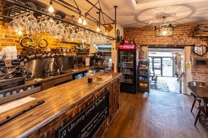 Bar serving alcoholic beverages as well as Super Duper coffee. at The Drop Off in Bury