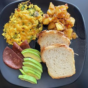 Vegan Breakfast/ papas salteadas, revoltillo de tofu con vegetales, jamón de soya, aguacate y pan de coco  at Green Bites in Dorado