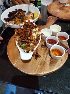 Fried mushroom with vegan mayo on top of fries at Veganerie - Silom in Bangkok
