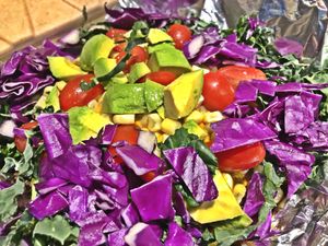 The Beastly Nachos!!!  Spiced blue corn chips smothered with 5 bean vegan chili, thick & smoky cheese sauce, kale, purple cabbage, sweet corn, sweet peppers, tomatoes, & avocado.  at Daily Fuel in Portland