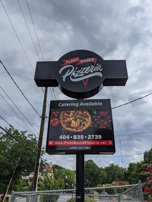 Sign with website and phone number at Plant Based Pizzeria in Atlanta