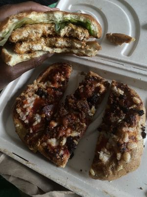 What’s left of ChickN sandwich & meatlovers flatbread pizza.  at Plant Based Pizzeria in Atlanta