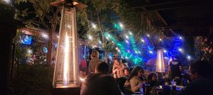 Outdoor garden seating with heat lamps for the cold season at 4th Street Fillin Station in Cocoa Beach