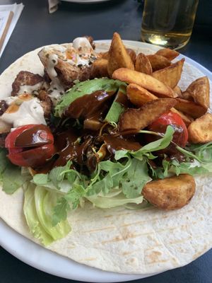 Baked cauliflower w/ avocado, rocket salad, tomatoes, tahin & wedges on a tortilla (just eat everything off the wrap until only juicy pieces remain, then wrap and enjoy the rest)  at Maschu Maschu in Vienna
