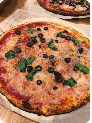 Vegan cheese pizza with spinach and black olives at Blaze Pizza in Miami