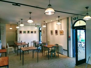 Seating area and art display at The Coal House Cafe in North London
