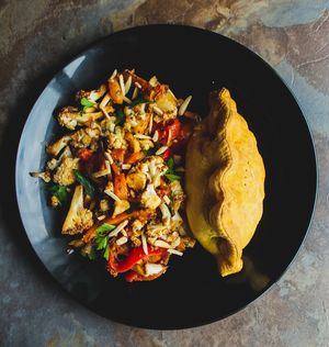 Curried Chickpea Patty (serving idea: with warm roasted cauliflower and pepper salad) at Amazing Ackee in Windsor