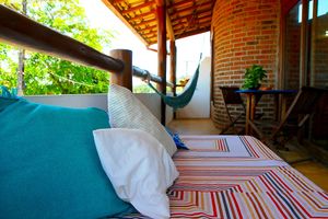 Balcony  where you can enjoy a breakfast while watching the view of the beach at Casa Kombar in Itacare