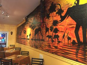 Great atmosphere, including hand-painted murals and masks. at Akadi in Portland