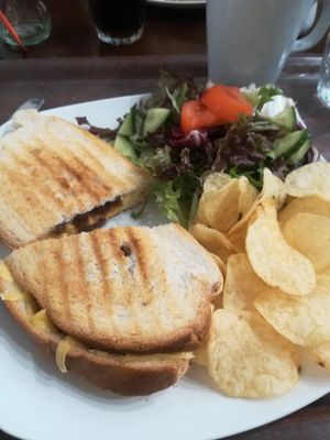 Vegan cheese and Red onion chutney toastie with crisps and salad.  at Monk's Kitchen Cafe in Gloucester