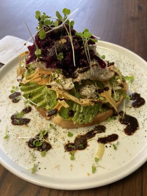 FUNK TOAST  $12
avocado. beet kraut. vegan cheese. micro greens. crispy onions. nutritional yeast. nori salt. balsamic reduction. at Organic Tree in Dana Point
