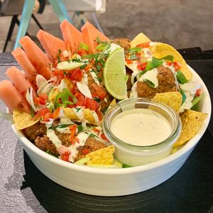 Buffalo Wings Salad with crispy seitan wings, watermelon, nacho chips, spring onion & ranch dressing at Sanba in Antwerpen