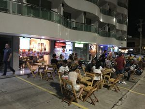 Sidewalk tables with a light breeze from the sea at Casa de Nara in Joao Pessoa