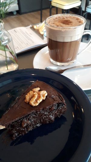 Perfect combo (for a sweet tooth): banana cacao and walnut cake + cappuccino (with almond milk). at Casa de Nara in Joao Pessoa