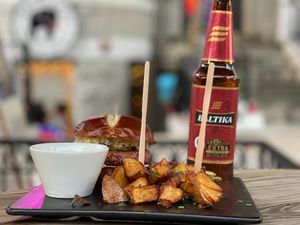 Vegan burger with Peasant potatoes, in-house made sauce, sauerkraut, and pickles. Paired with Baltika 9, Russian dark lager. at sPACYcLOUd Lounge in Washington