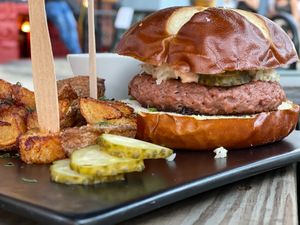 Vegan burger with Peasant potatoes, in-house made sauce, sauerkraut, and pickles.  at sPACYcLOUd Lounge in Washington