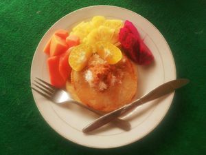 Vegan coconut pancakes made from fresh coconut, local fredh fruit and coconut sugar at Maruf Devi Rasta Cafe in Medewi