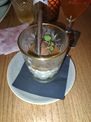 Dessert; tumbler with pear, cream, chocolate mouse and caramel sauce. at Slot Oostende in Goes