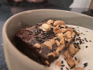 Brownie with coconut whipped cream topped with peanuts at Camion in Antwerpen