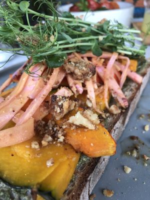 Sourdough bread, pumpkin seed butter, grilled pumpkin, pickled ramenas and caramelised walnuts  at Camion in Antwerpen