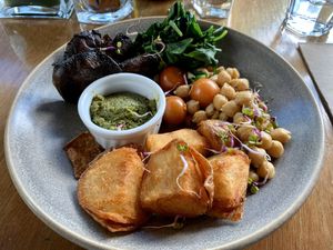 Breakfast: roasted potatoes, spiced chickpeas, spinach, mushrooms, and cherry tomatoes with basil pesto.  at Halo in Queenstown