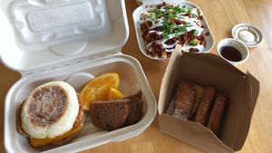 Loaded breakfast sandwich, soyrizo fries, & cinnamon toast sticks at Plant Slayer in Fresno