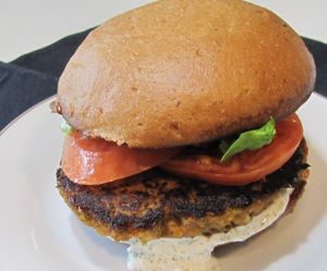 Crab-less croquet (Artichokes, garbanzo beans, celery, onions, panko, vegan mayo, herbs, spices) on a whole wheat bun with lettuce and tomato at A Full Taste in Decatur