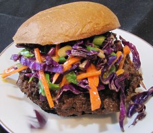 Jerked jackfruit sandwich (jack fruit, jerked spices and sauce) topped with fresh crunchy slaw (cabbage, onions, scallions, mango, carrots, slaw dressing) on a cornmeal roll at A Full Taste in Decatur