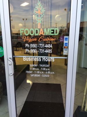 Front door with hours at Foodamed in Mc Allen