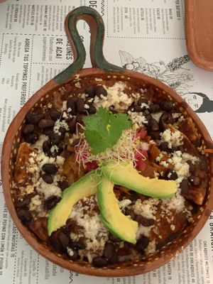 Chilaquiles Mayoras - vegan Mexican meal with black beans and jackfruit, homemade salsa and tortillas with tapioca cheese and avocado topping.  at La Casa de las Mayoras in Cancun
